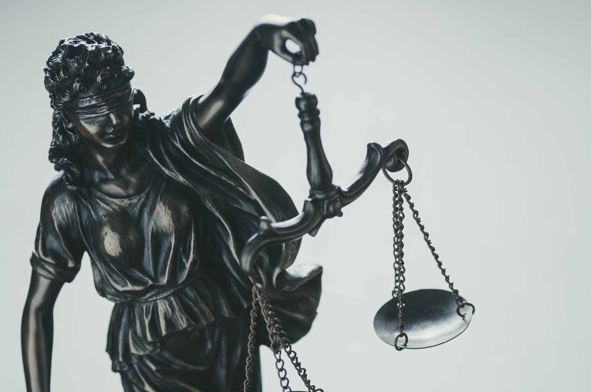 Statue of Justice holding aloft scales